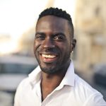 Selective Focus Photo of Smiling Man in White Dress Shirt